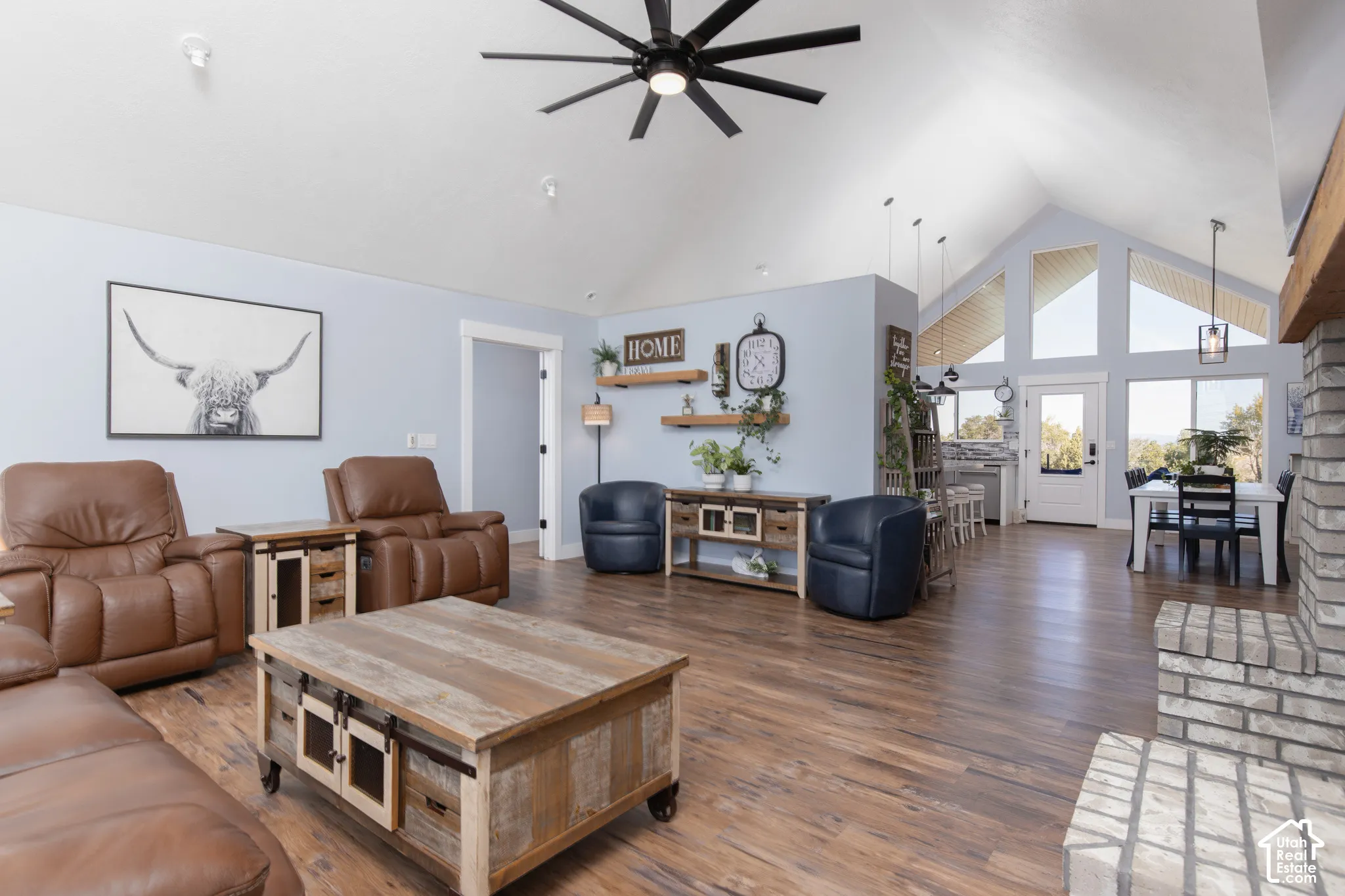 Vaulted ceilings, wood-finish flooring, and a stone-clad fireplace