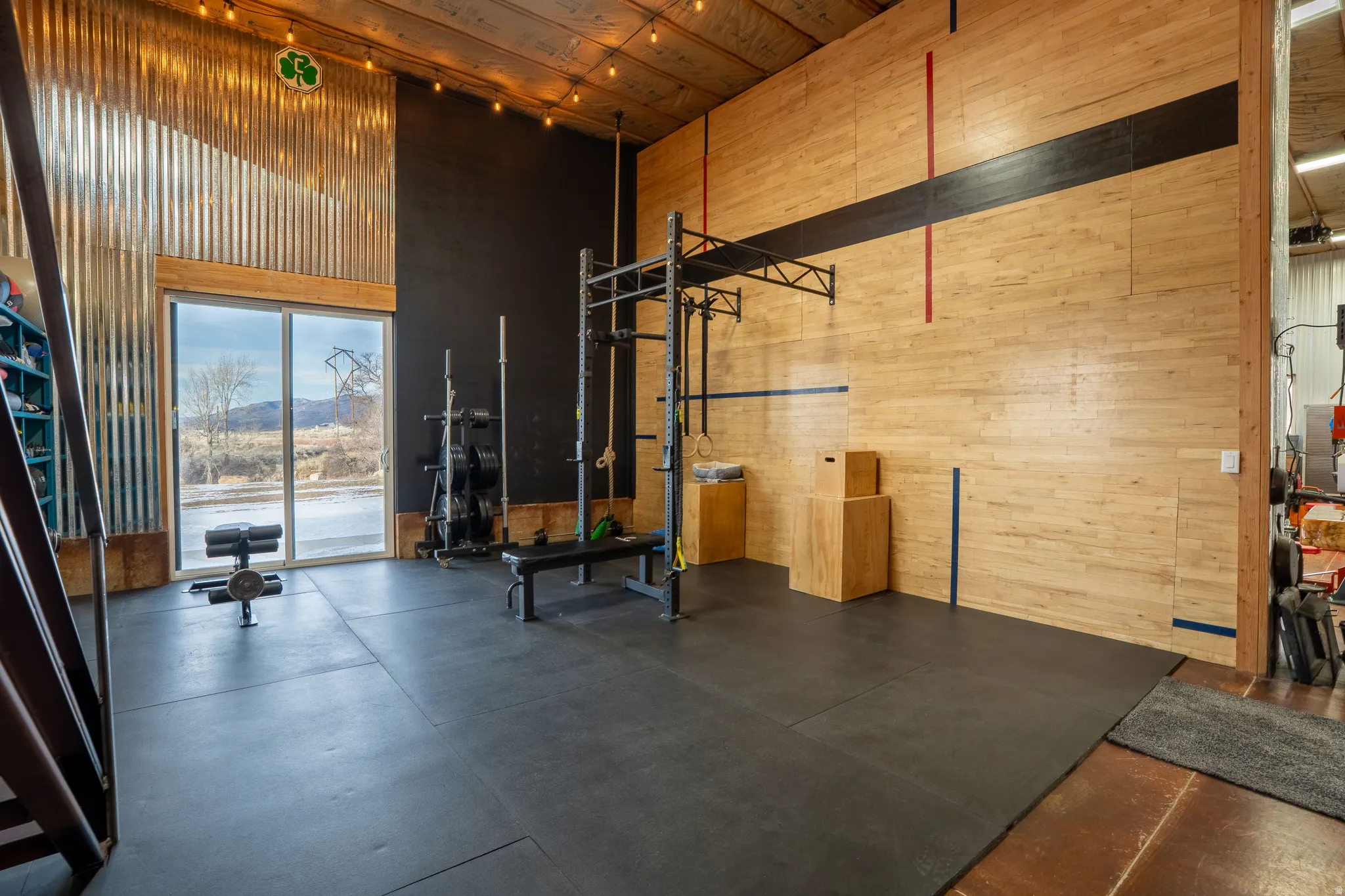Workout room featuring wooden walls and a high ceiling