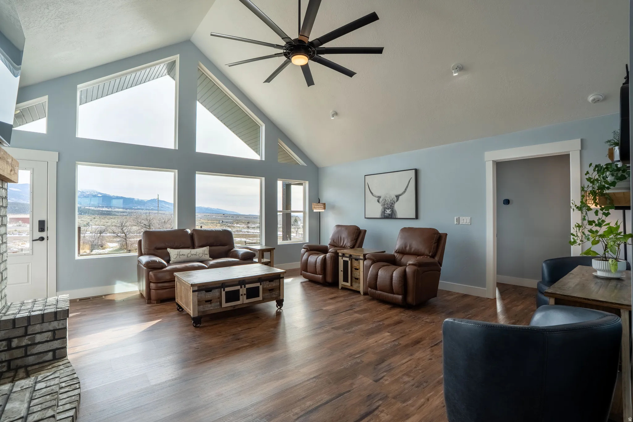 Living room with vaulted ceiling, mountain views, oversized ceiling fan