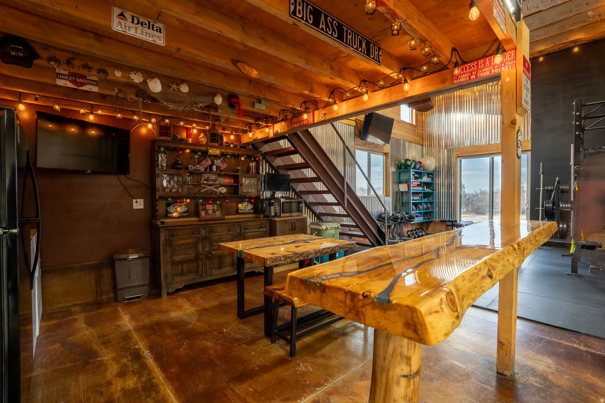 Dining space with stairway and concrete flooring