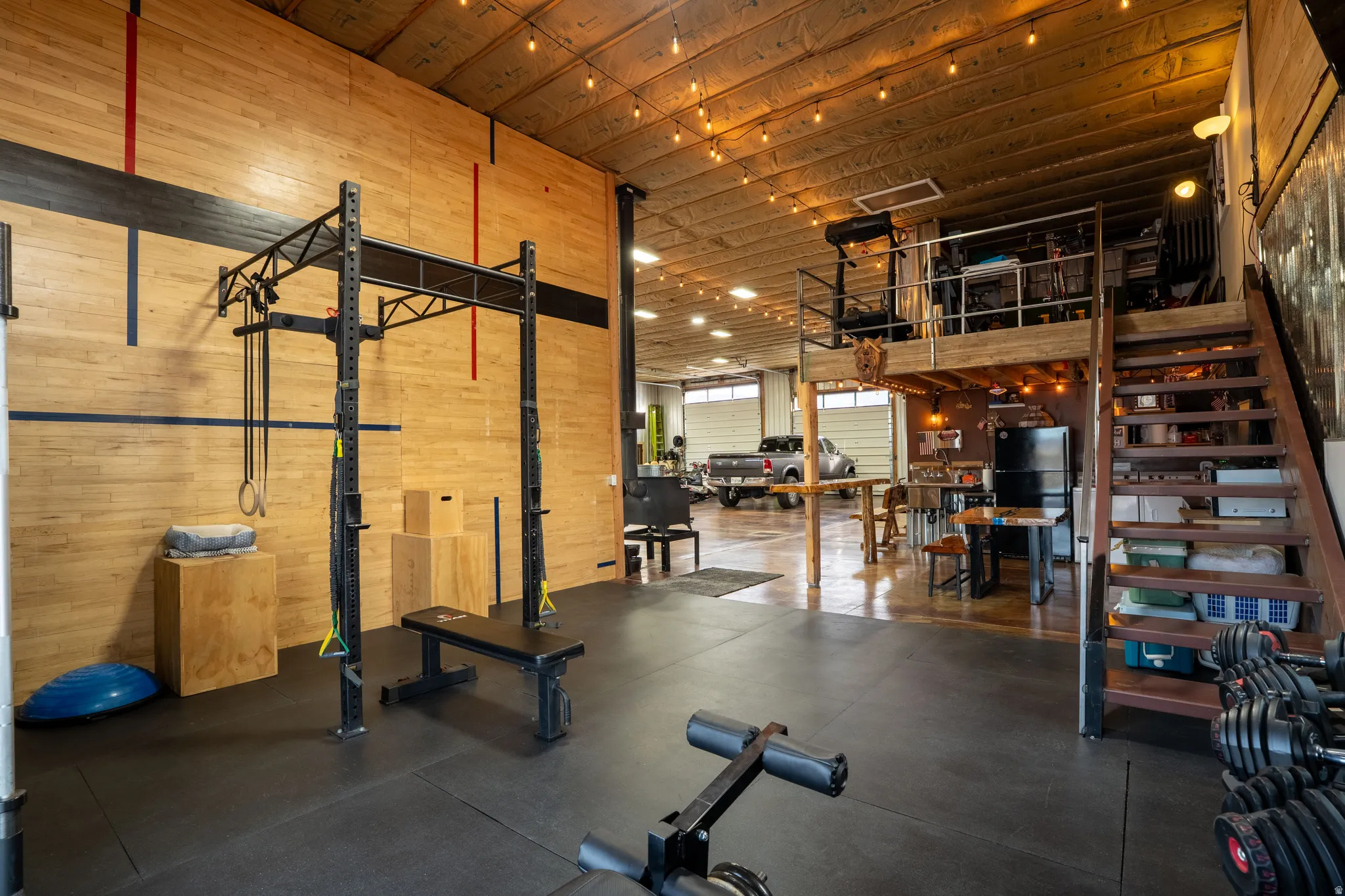 Exercise area featuring wooden walls and a high ceiling