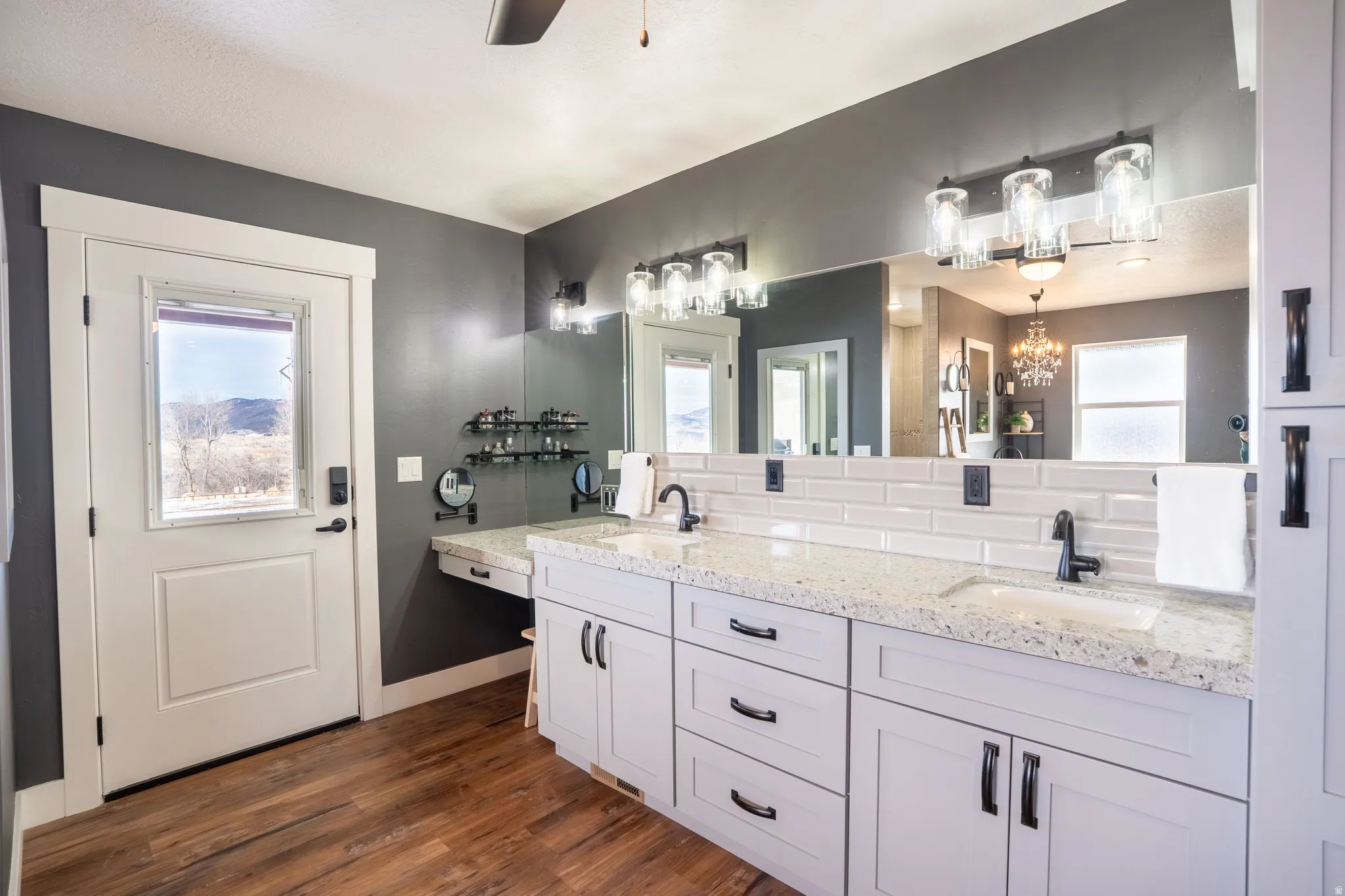 Full bathroom with double vanity, make-up counter exterior door to the backyard