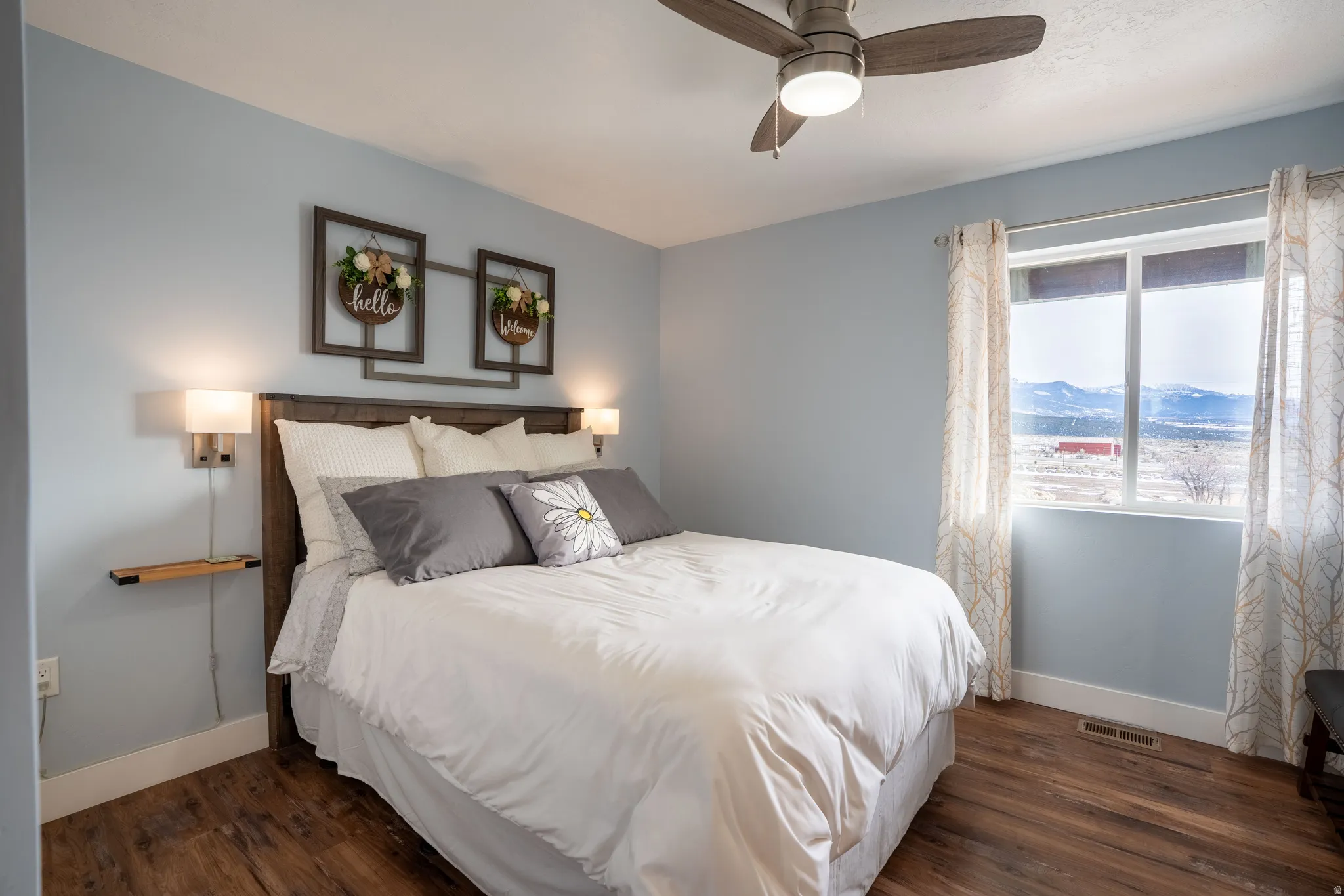 Bedroom 2 with LVP flooring, a mountain view, and ceiling fan
