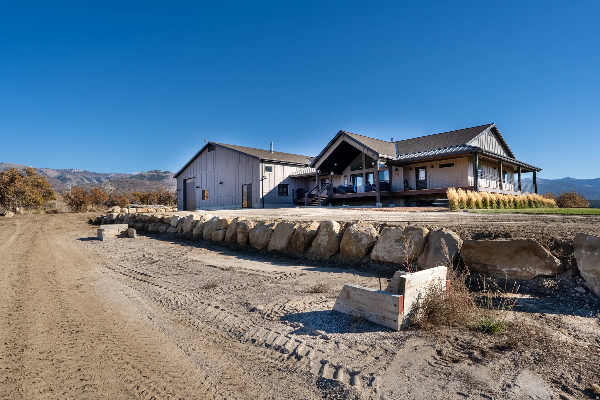 Back of house featuring a mountain view, a standing seam roof, and a balcony