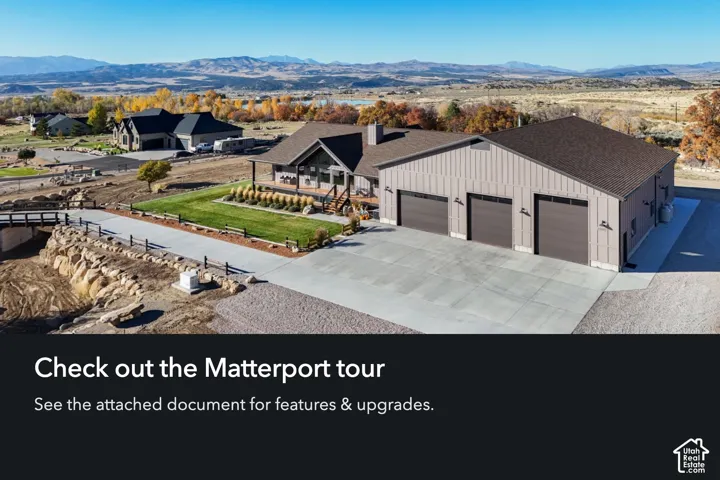 Expansive exterior featuring a multi-bay garage, large concrete driveway, covered porch, and mountainous backdrop