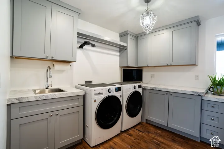 Laundry room with separate washer and dryer, cabinets, sink