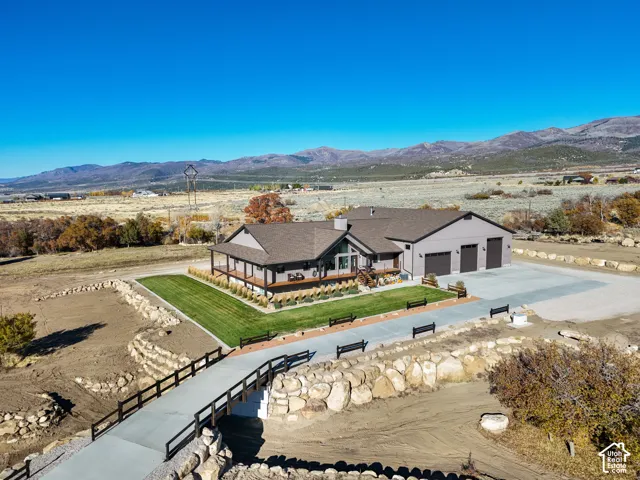 Aerial view of a mountainous background and concrete driveway with bridge