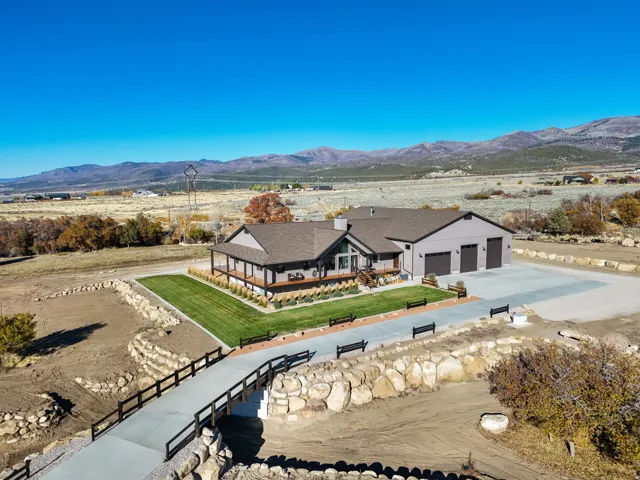 Aerial view of a mountainous background and concrete driveway with bridge