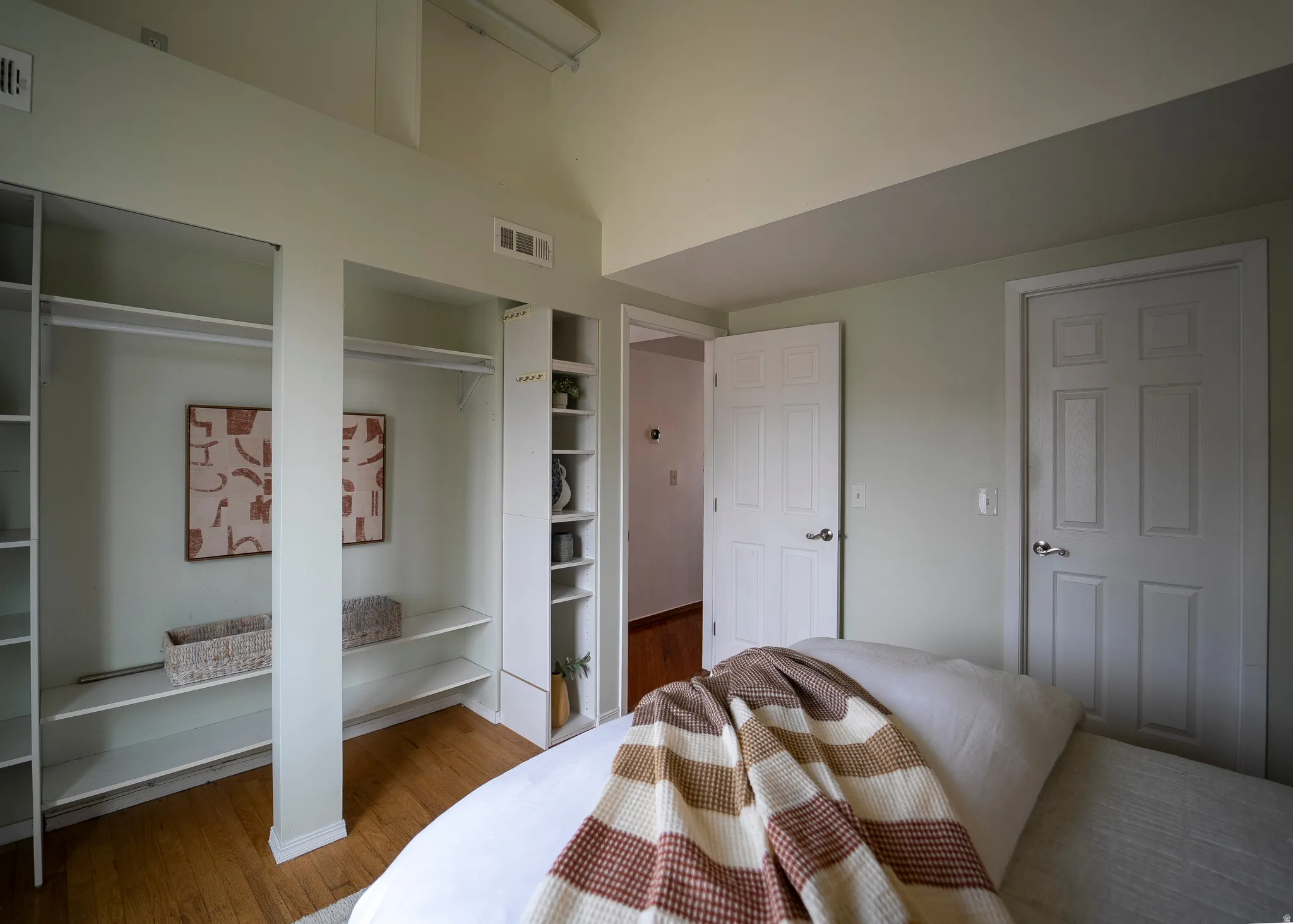 Bedroom featuring two closets and wood finished floors