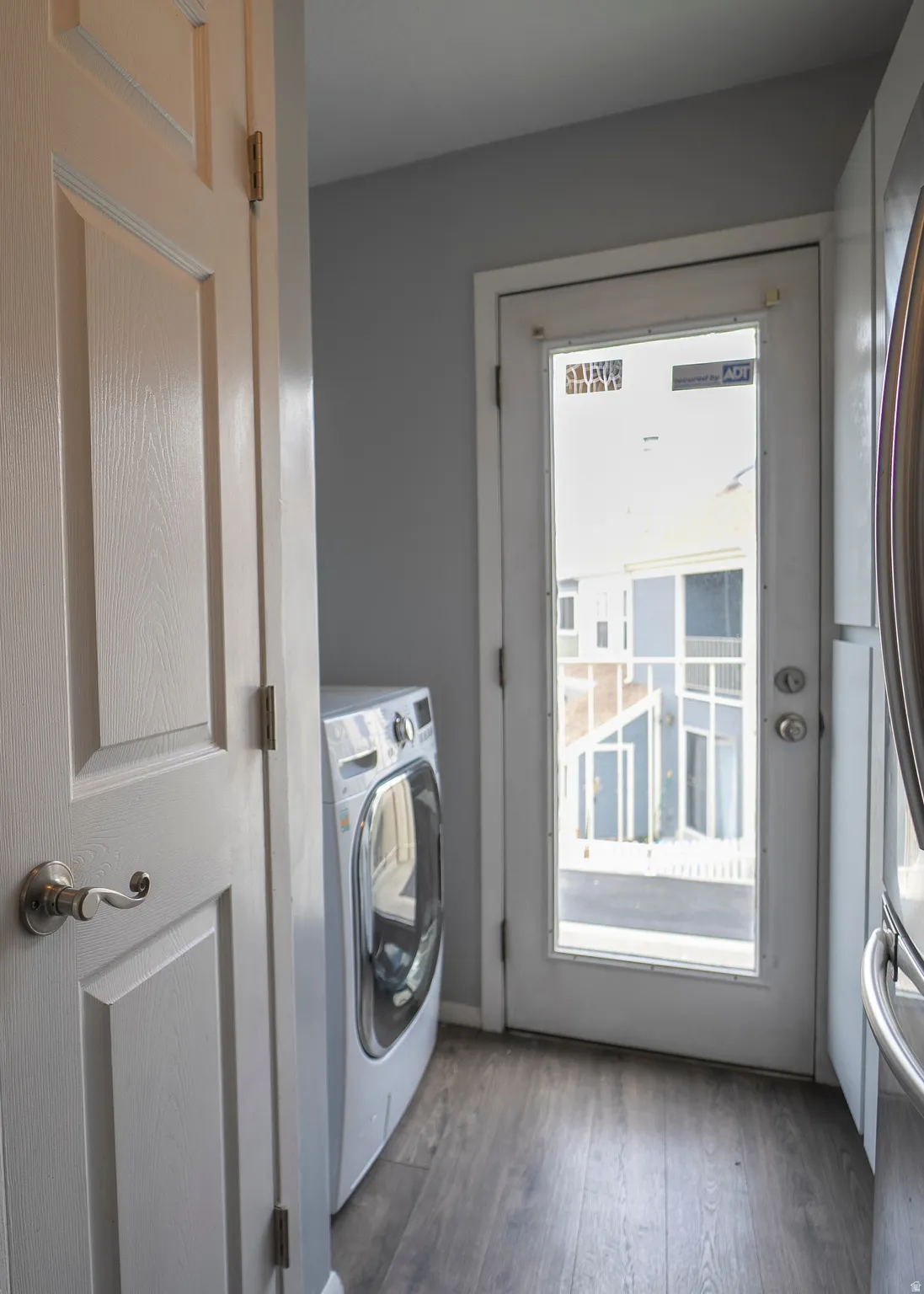 Laundry area featuring washer / clothes dryer and dark wood-type flooring