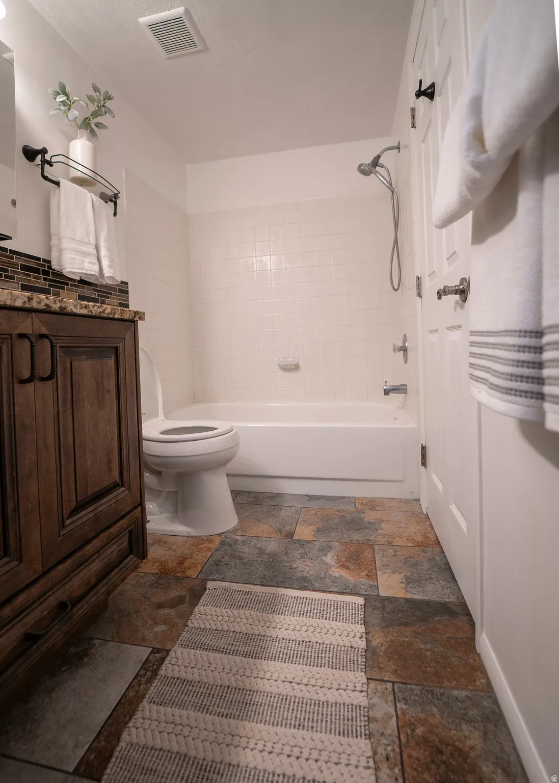 Bathroom with shower / bathtub combination and vanity