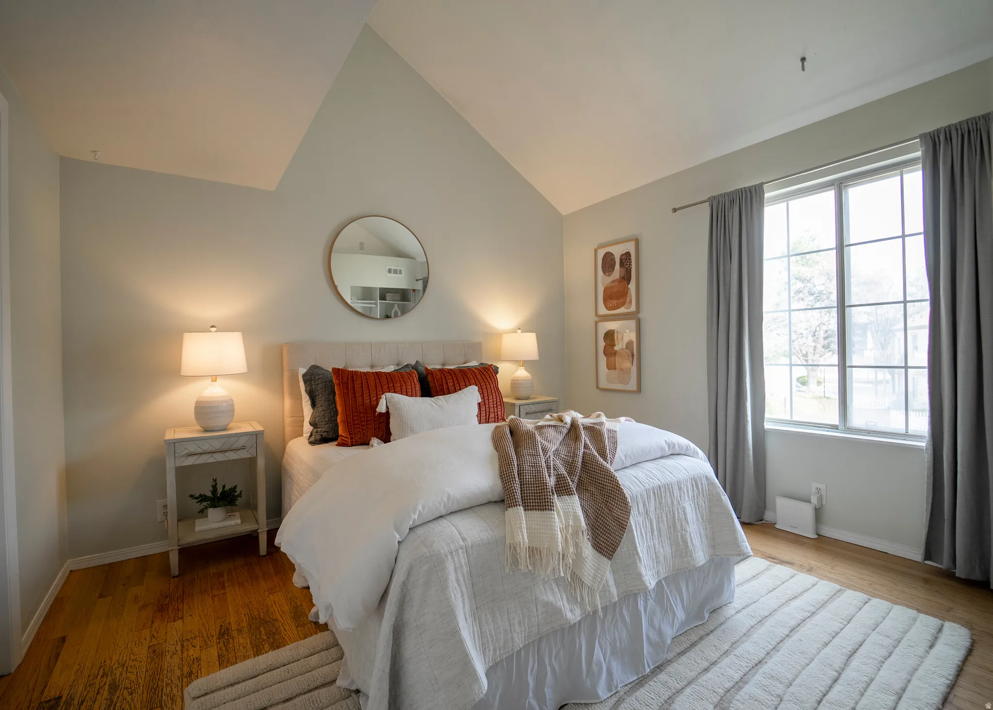 Bedroom featuring lofted ceiling and wood finished floors