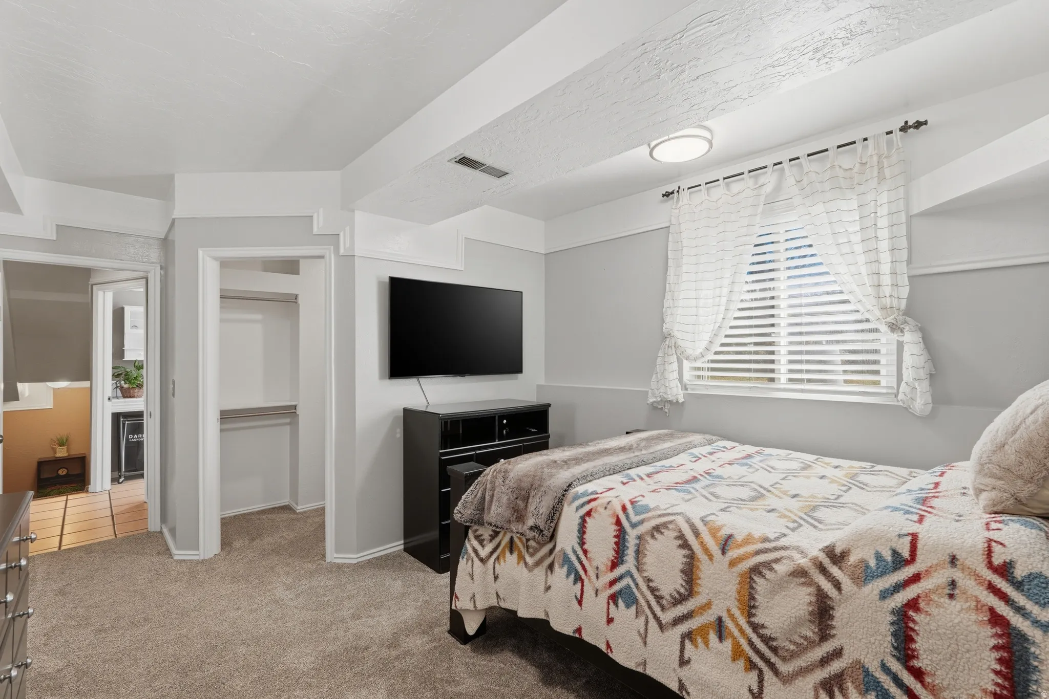 Carpeted bedroom with baseboards