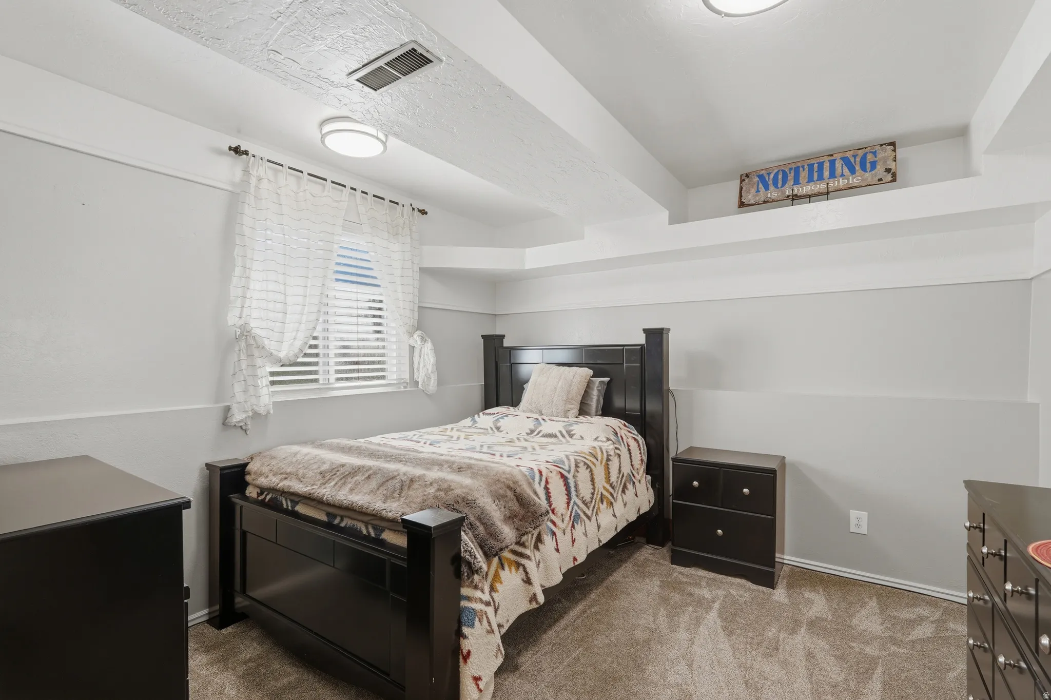 Carpeted bedroom featuring baseboards