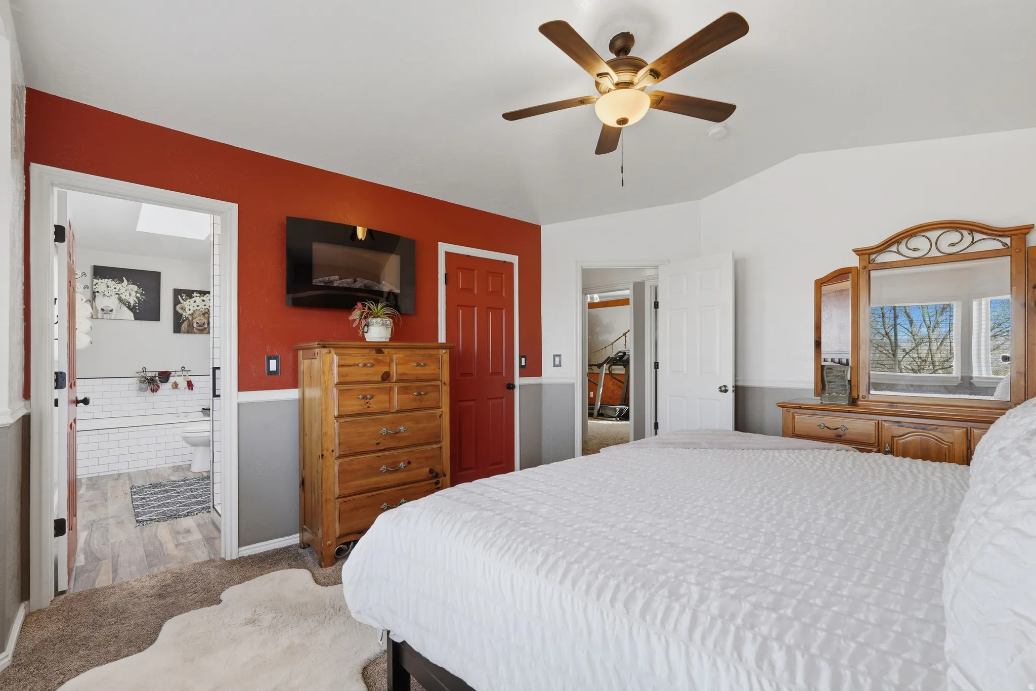 Bedroom with carpet flooring, a ceiling fan, and vaulted ceiling