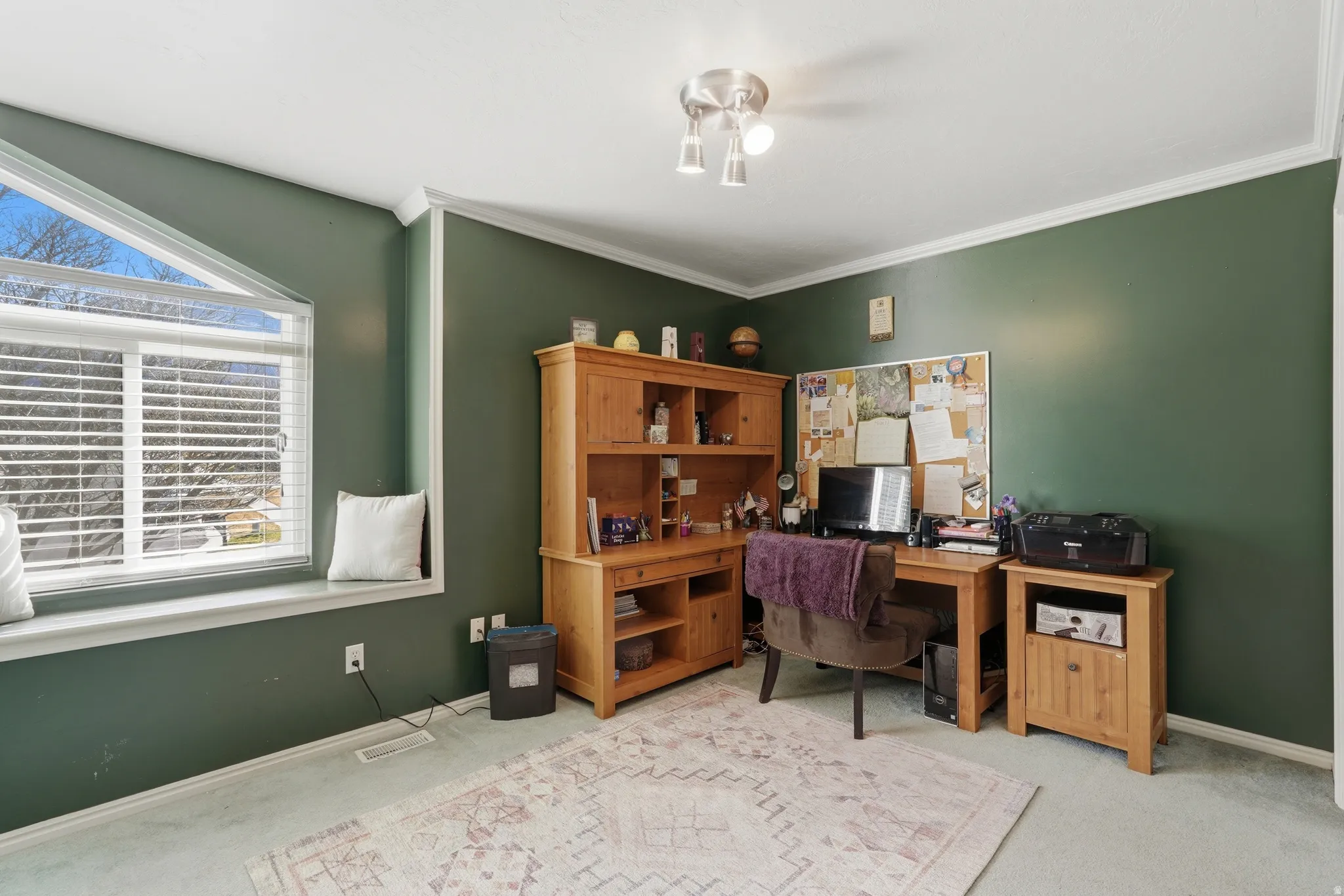 Office space featuring light carpet and ornamental molding