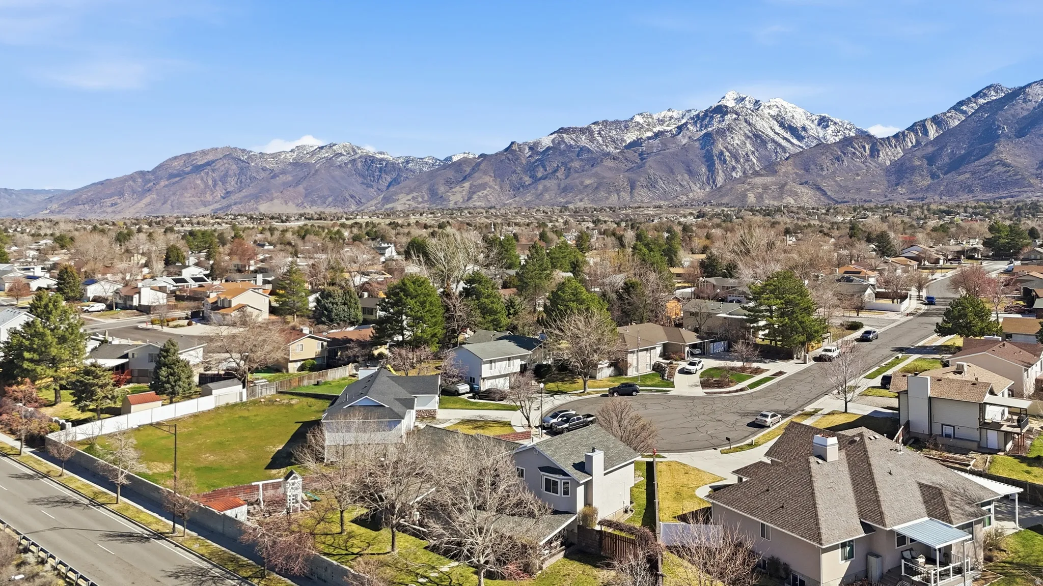 Aerial perspective of suburban area featuring a mountainous background
