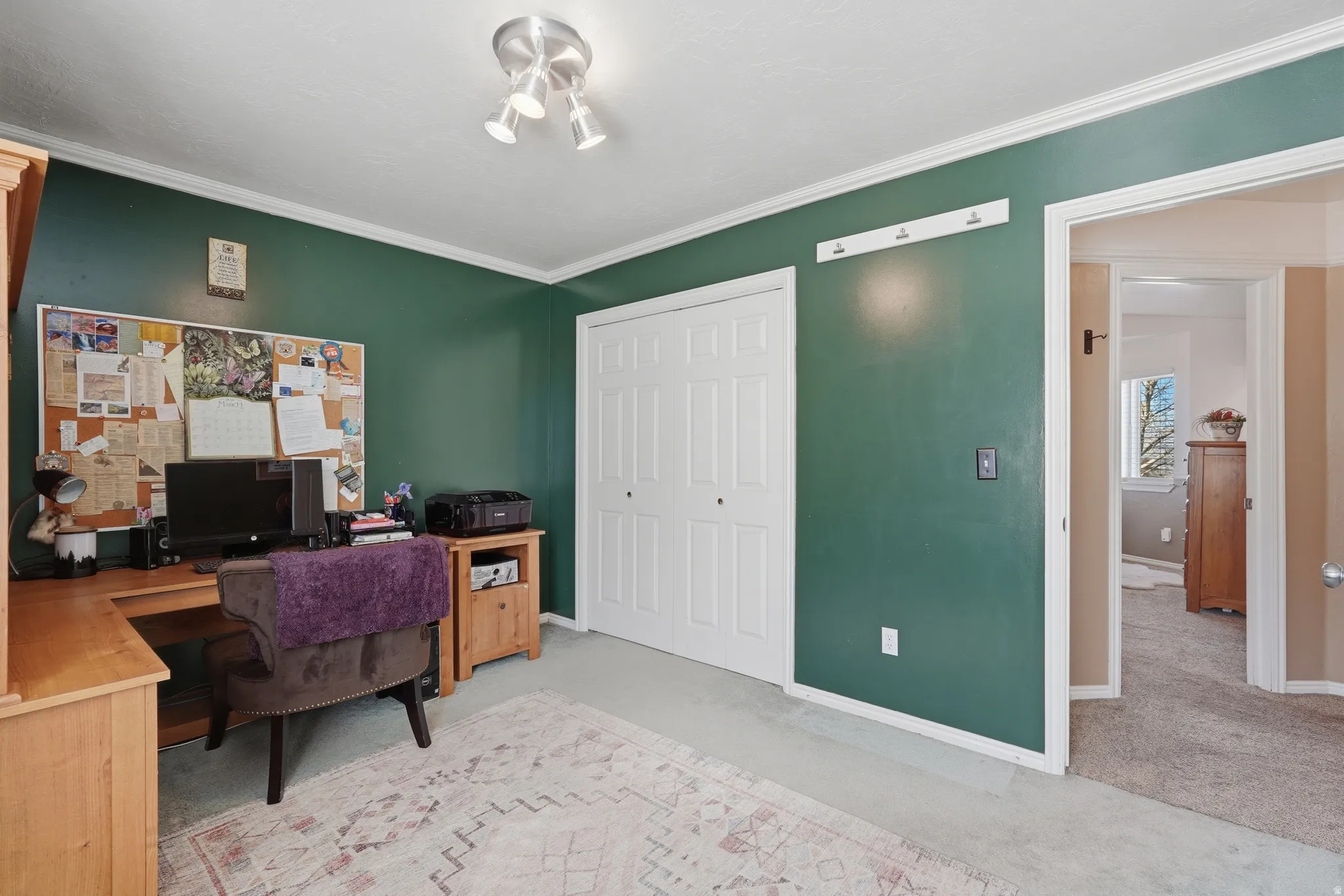 Office space featuring light carpet and ornamental molding
