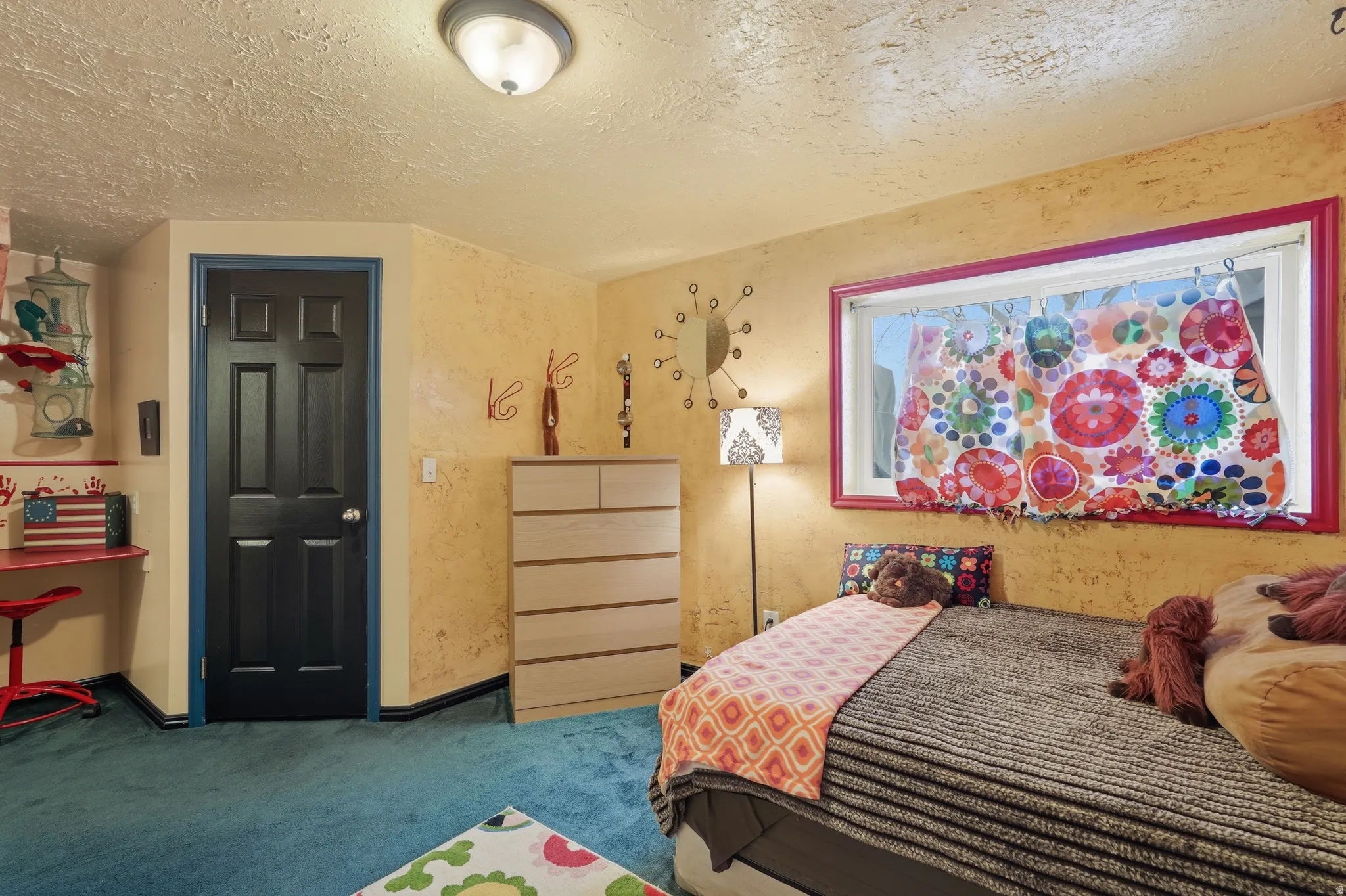Bedroom with a textured ceiling and carpet floors