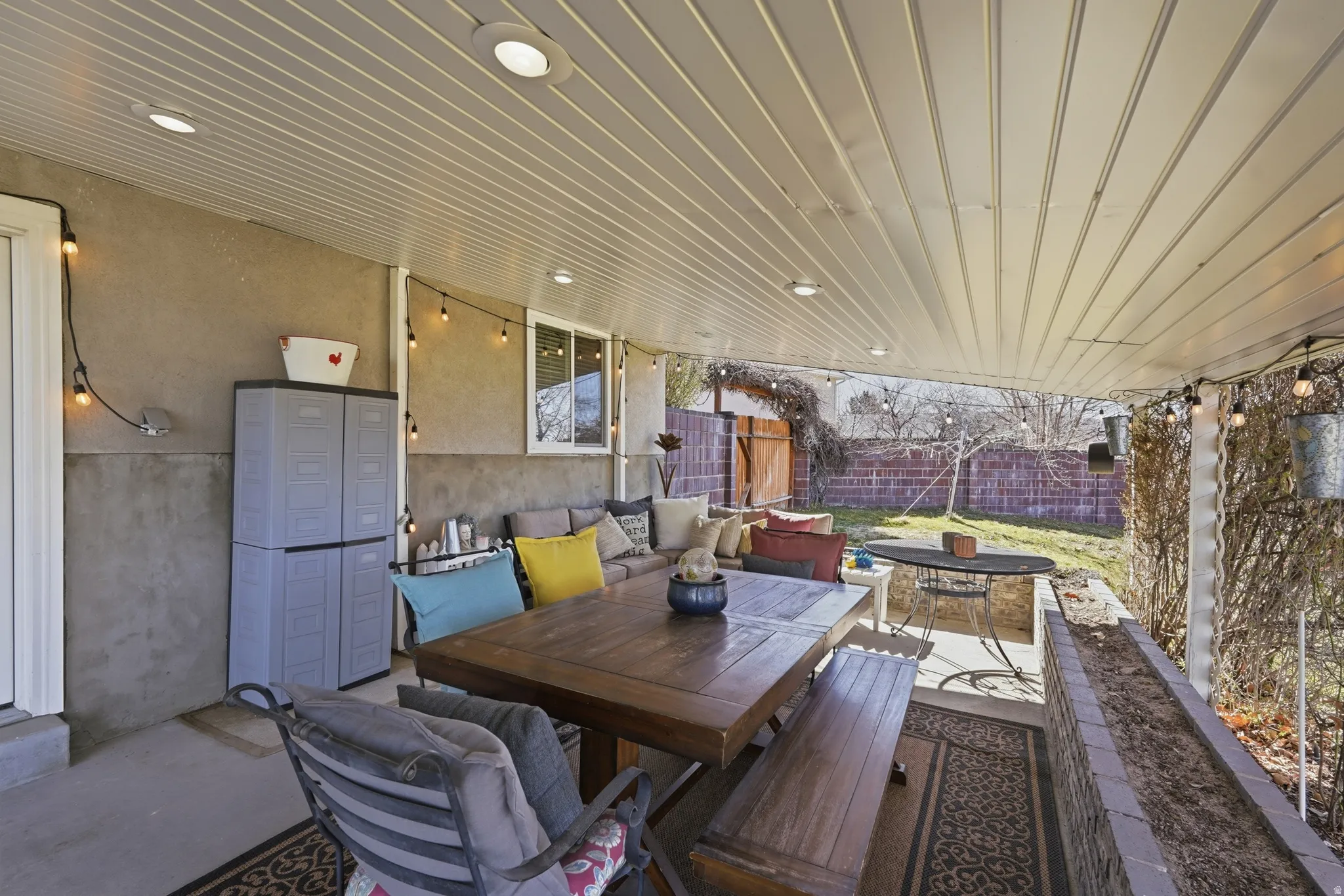 Fenced backyard featuring an outdoor living / dining area and a patio area