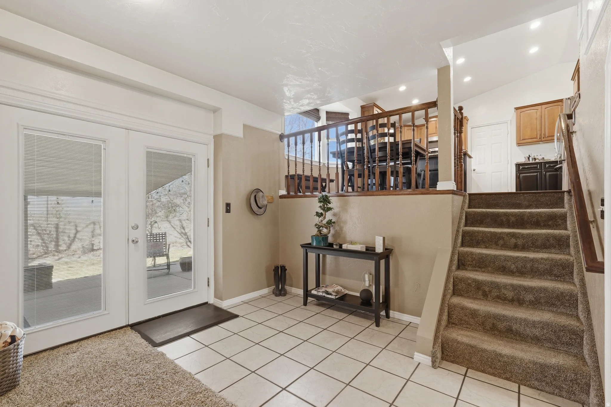 Staircase featuring tile patterned floors, french doors, and recessed lighting