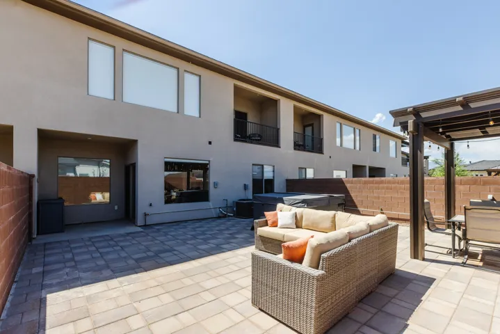 View of patio featuring a hot tub and an outdoor lounge area