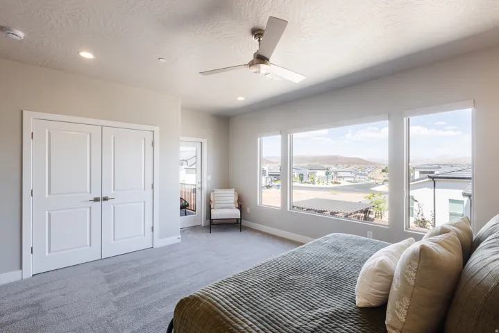 Carpeted bedroom with a ceiling fan, access to exterior, a mountain view, a textured ceiling, and recessed lighting