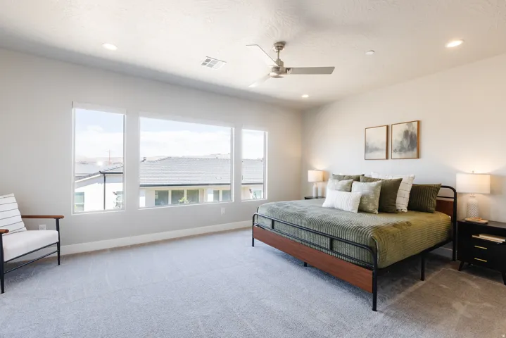 Bedroom with light carpet, a ceiling fan, and recessed lighting