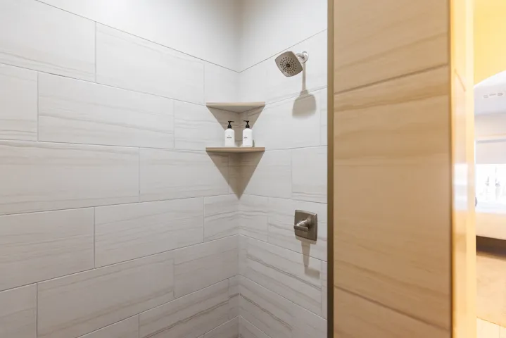 Full bathroom featuring a tile shower and ensuite bathroom