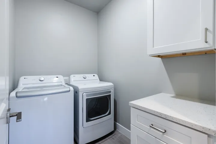 Laundry room with cabinet space and separate washer and dryer