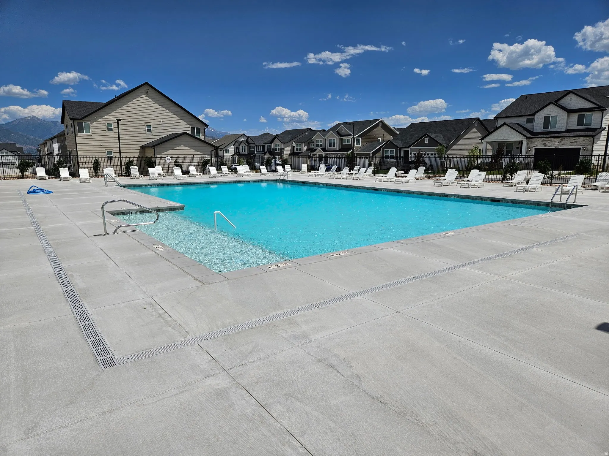 Community pool featuring a patio area and a residential view