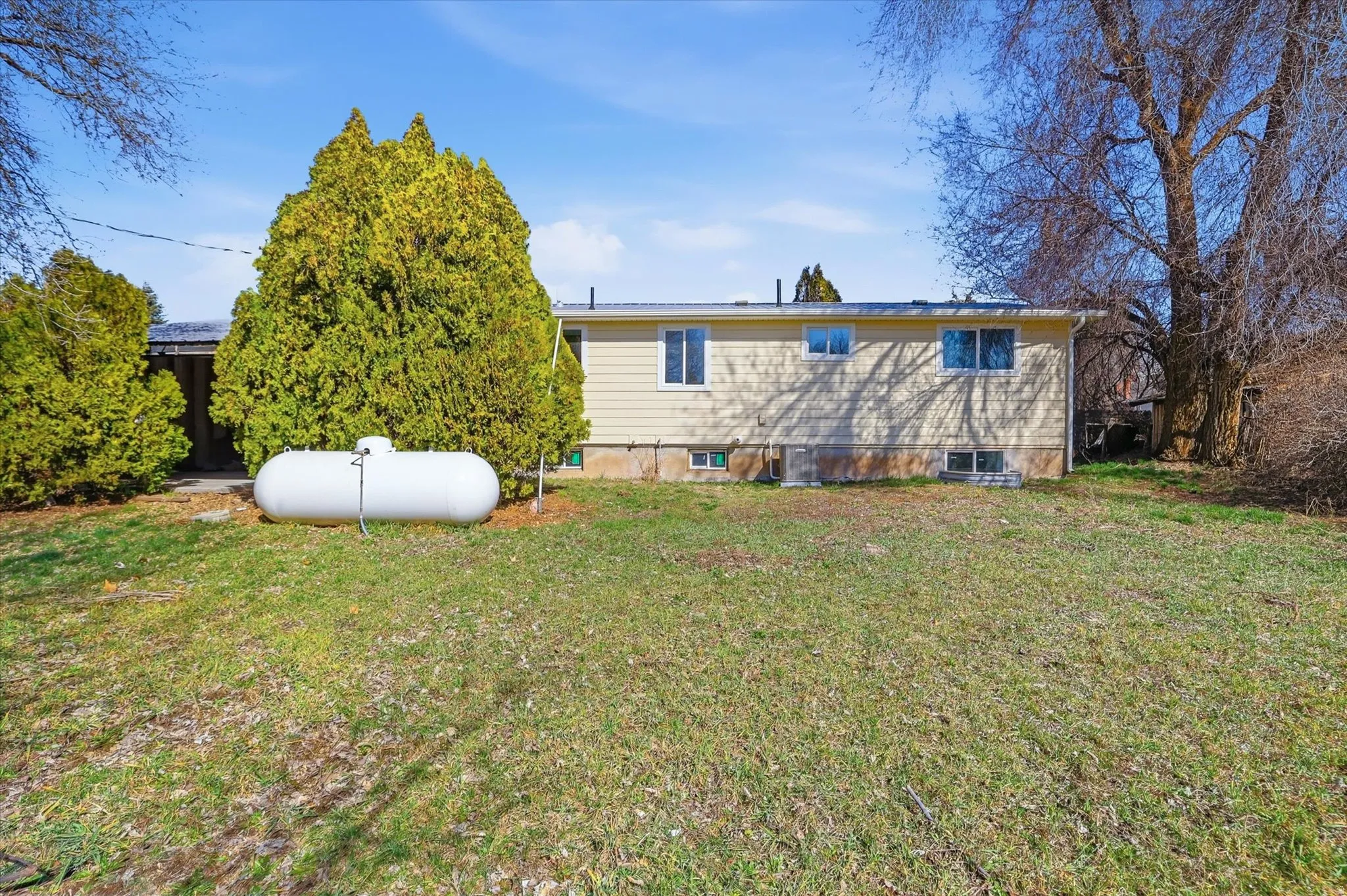 Rear view of property featuring a yard