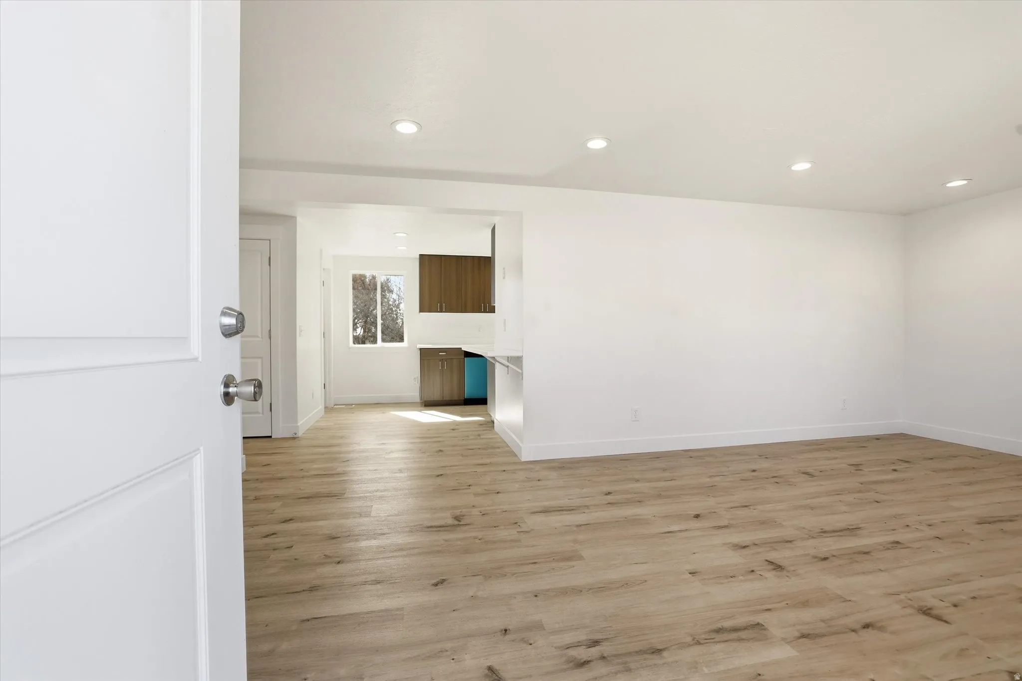 Spare room featuring light wood finished floors and recessed lighting