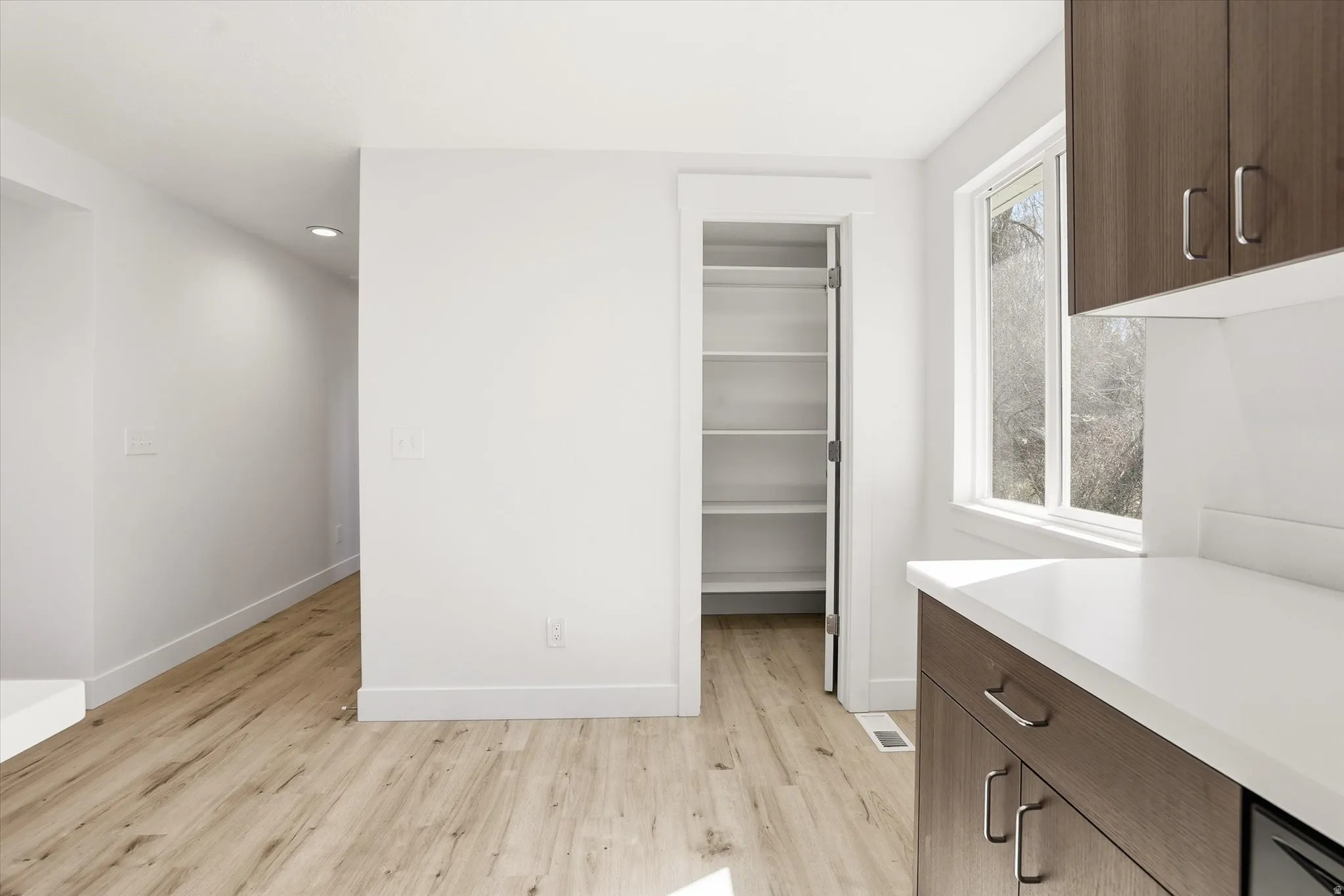 Unfurnished dining area with light wood-style floors and recessed lighting
