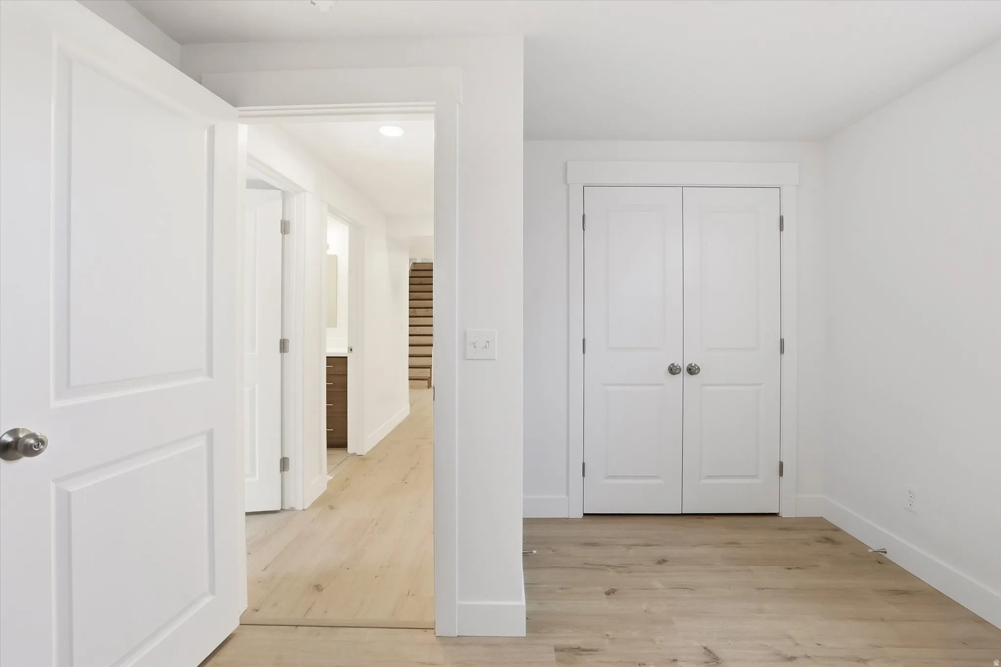 Unfurnished bedroom featuring light wood-style floors and a closet