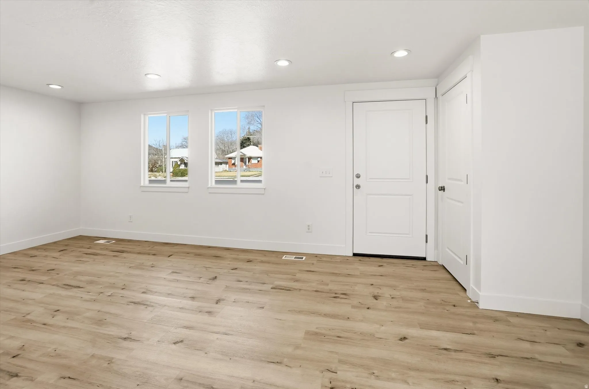 Spare room with light wood-style flooring and recessed lighting