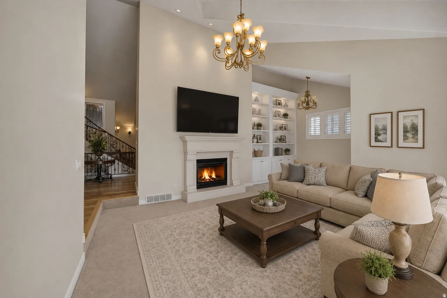 Living area featuring a fireplace with a mantel, built-in shelving, high ceilings, and recessed lighting