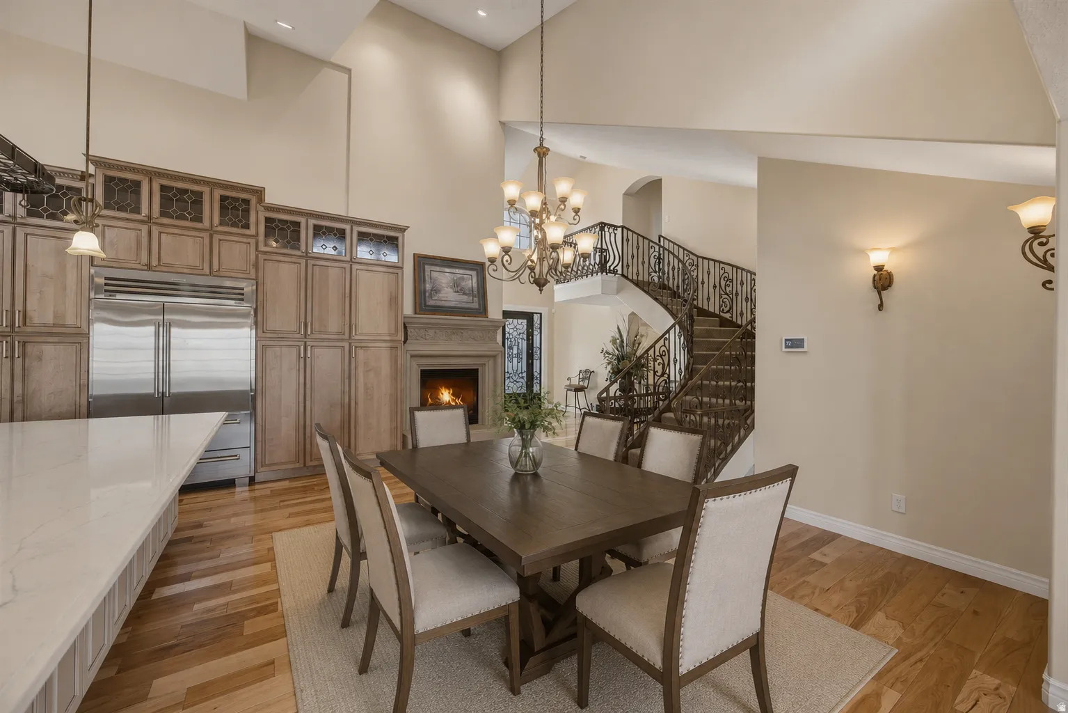 AI version of dining next to island. Dining area featuring a vaulted ceiling and wood-finish flooring