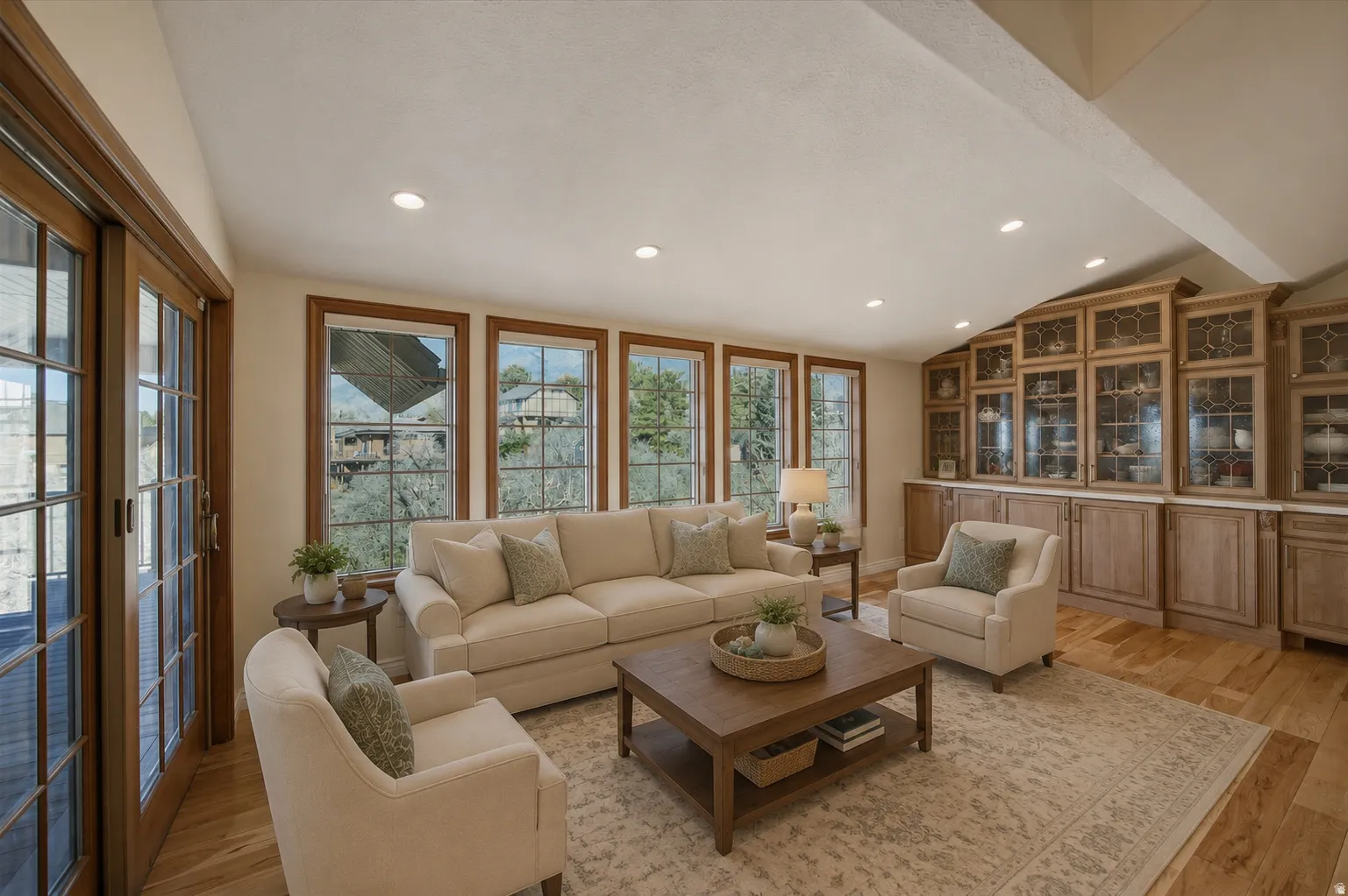 AI version of sunroom off kitchen Bright living space featuring wood-finish flooring and recessed lighting