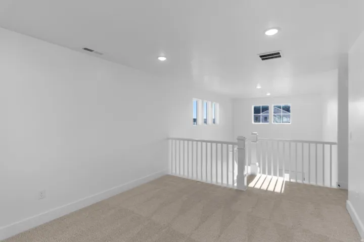 Unfurnished room featuring carpet flooring and recessed lighting