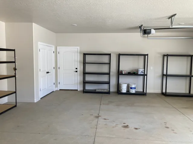 Spacious garage with light-toned walls and a durable concrete floor