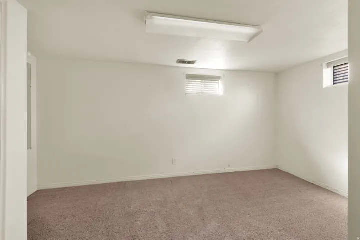 Carpeted spare room with plenty of natural light