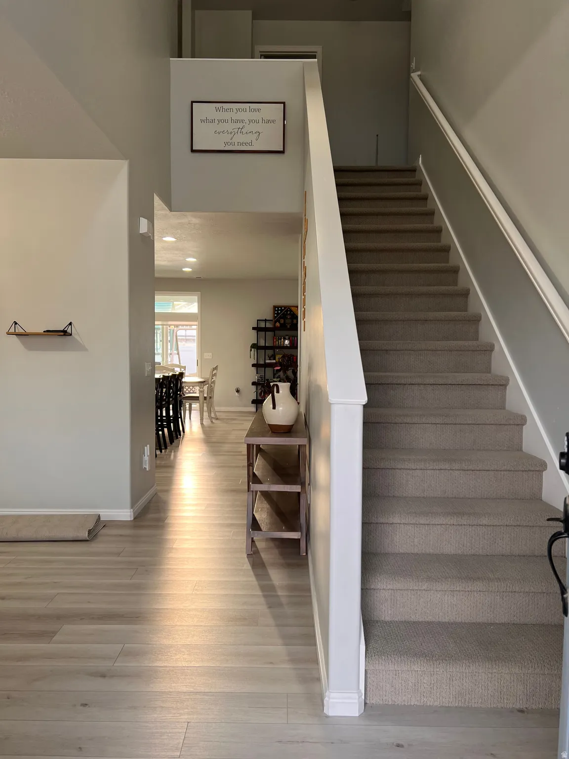 Stairs to 2nd level with recessed lighting, and high ceiling