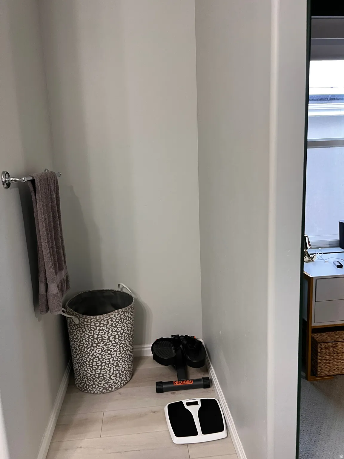 Master Bathroom nook with detailed view of baseboards and wood finished floors