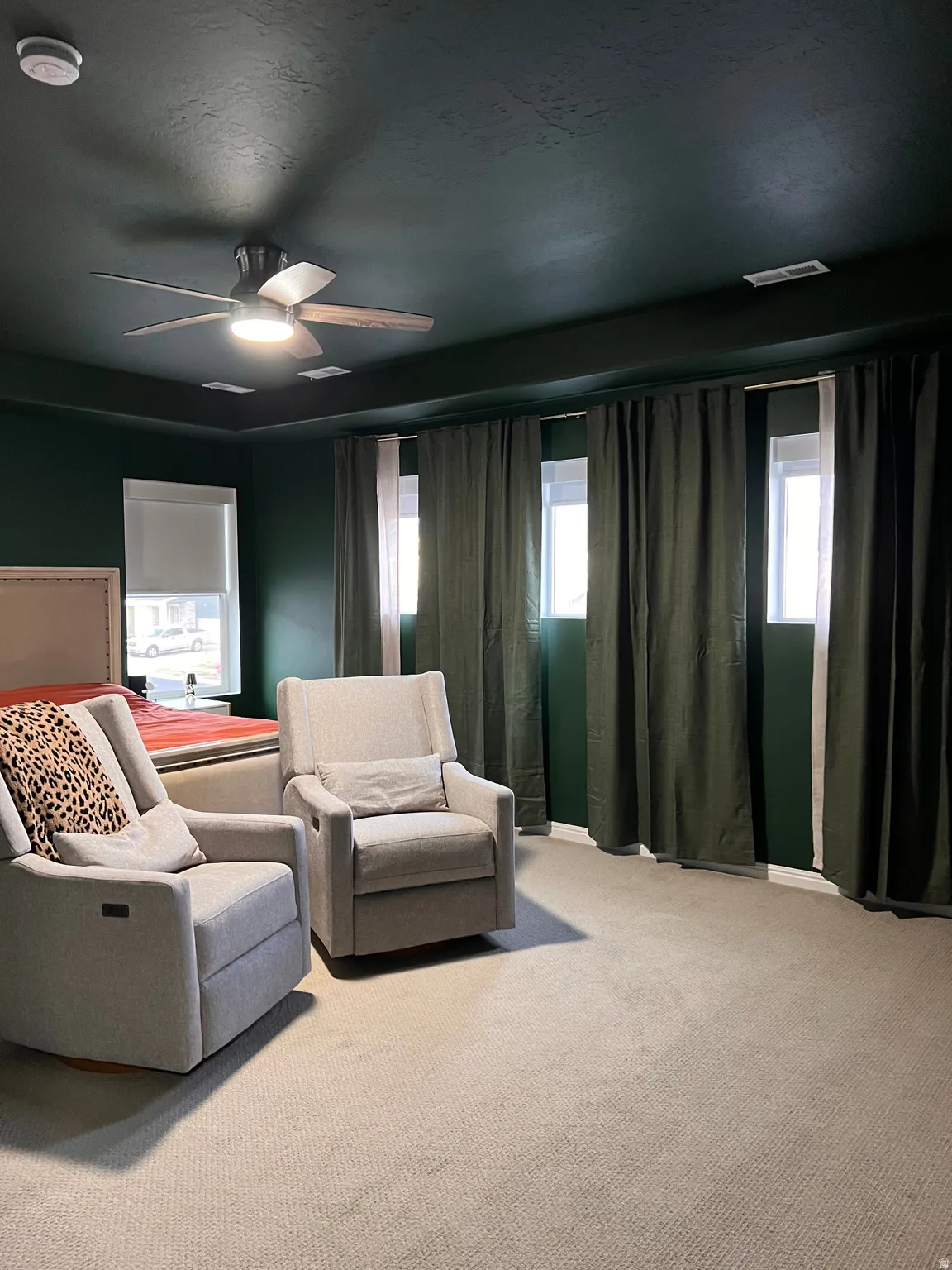 Master bedroom with windows and draperies