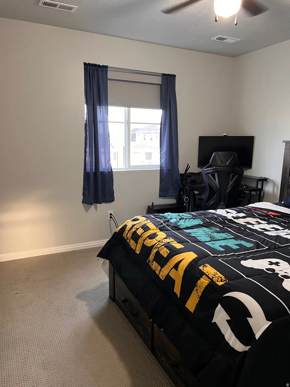 Carpeted bedroom with baseboards and a ceiling fan