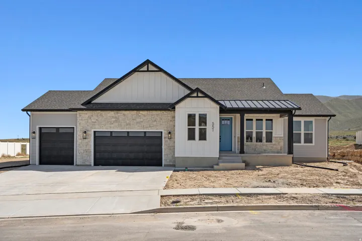 Modern inspired farmhouse with an attached garage, driveway, covered porch, board and batten siding, and roof with shingles