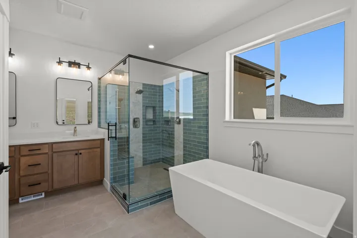 Bathroom with vanity, a soaking tub, a shower stall, light tile patterned flooring, and recessed lighting