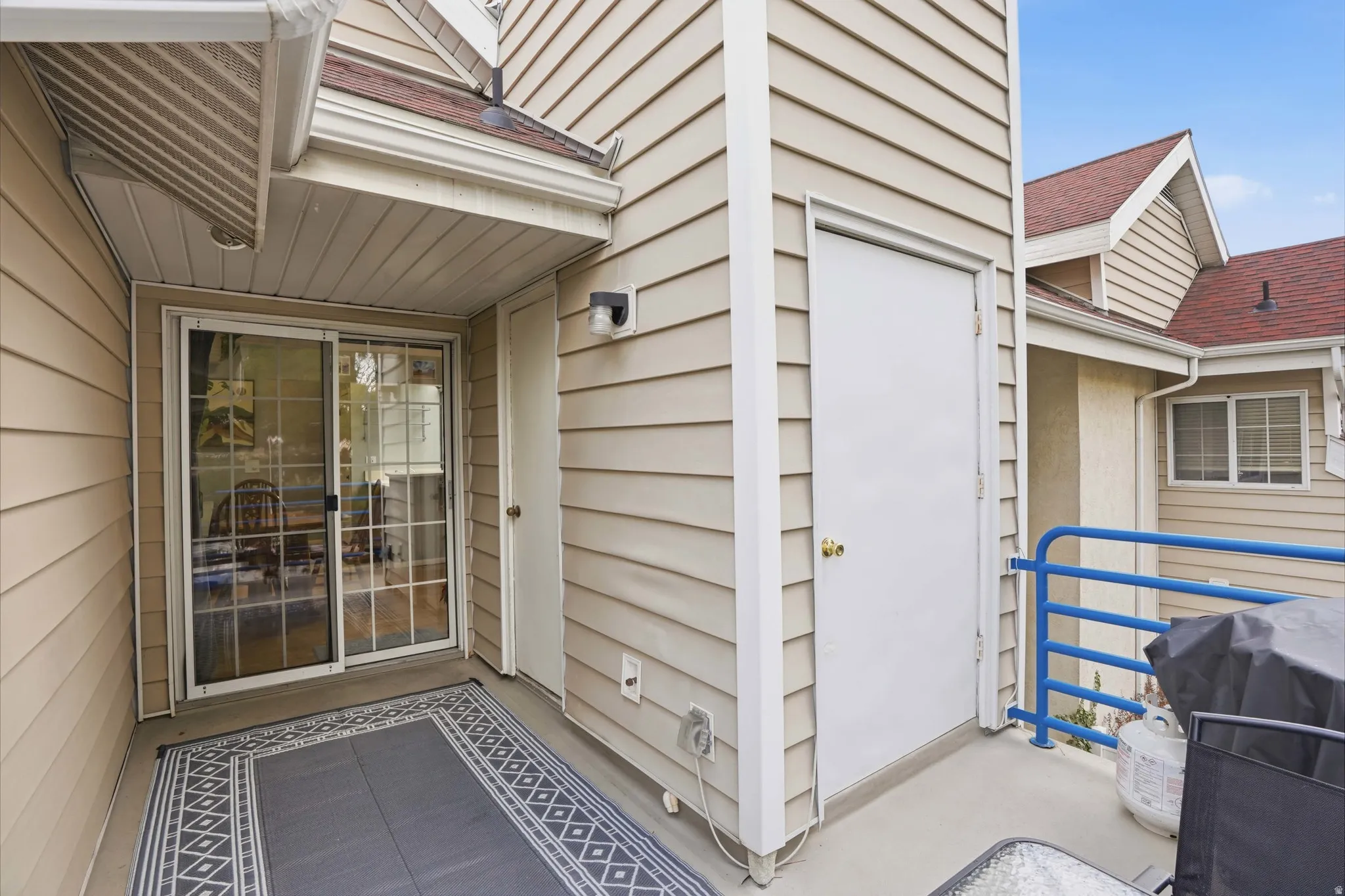 Doorway to property featuring roof with shingles