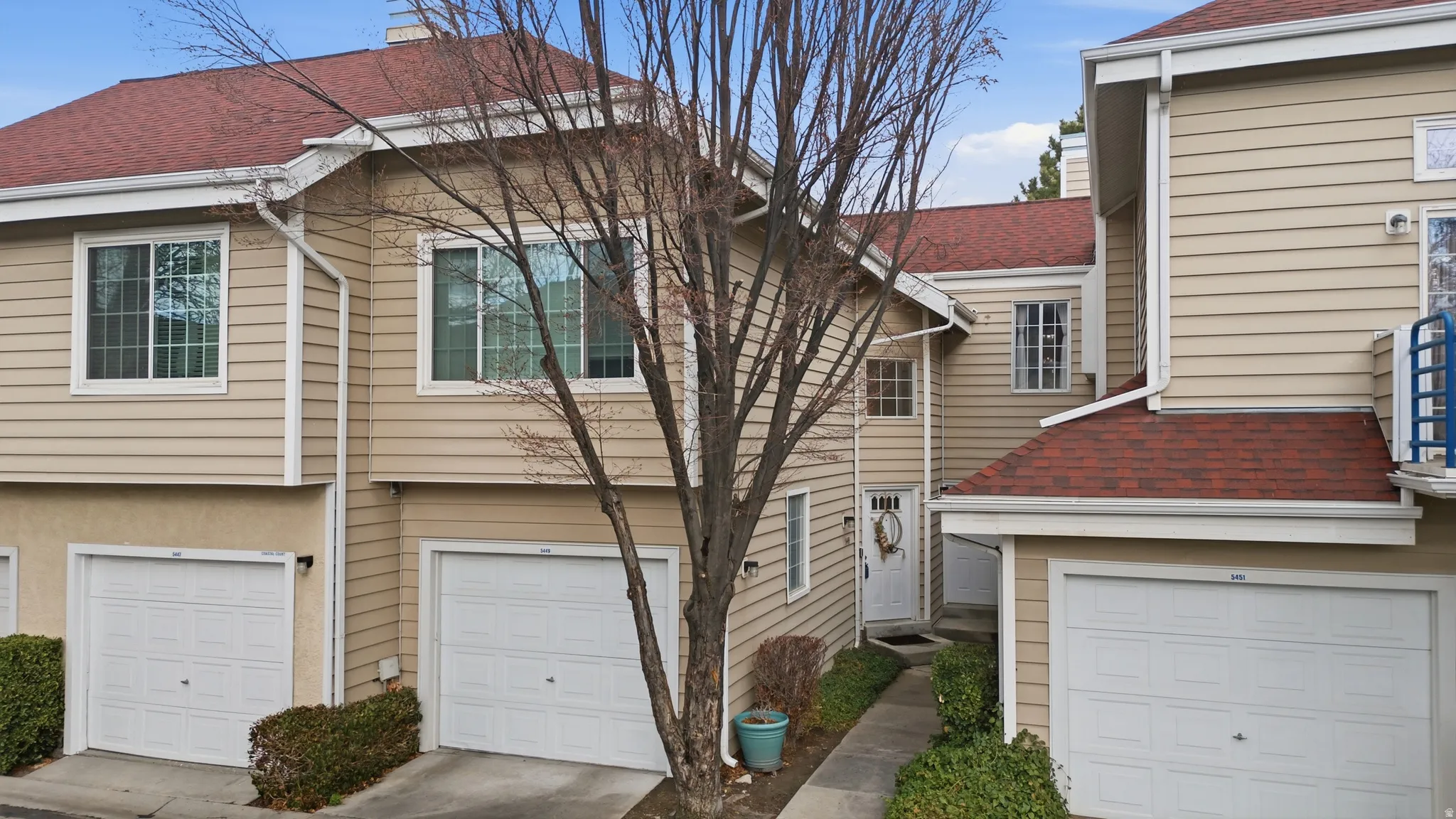 Traditional-style home featuring roof with shingles and an attached garage